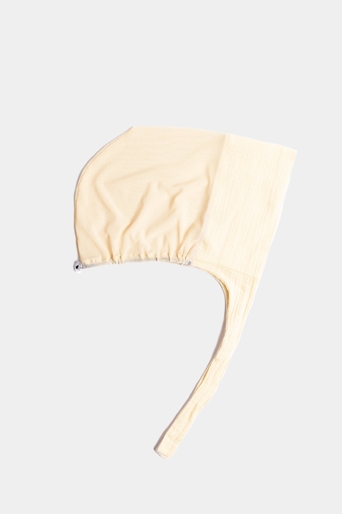 a buttercream cotton mesh underscarf with ties
shown flat against a light gray background.