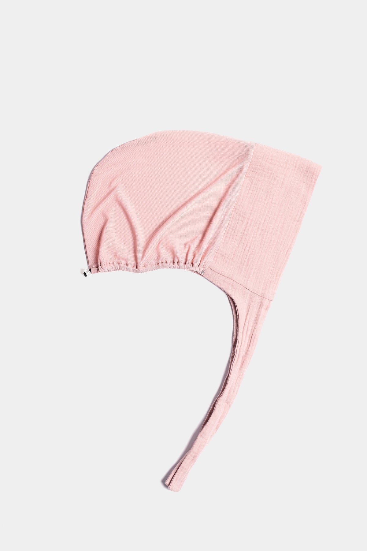 a light pink  cotton mesh underscarf  with ties shown flat against a light gray background.