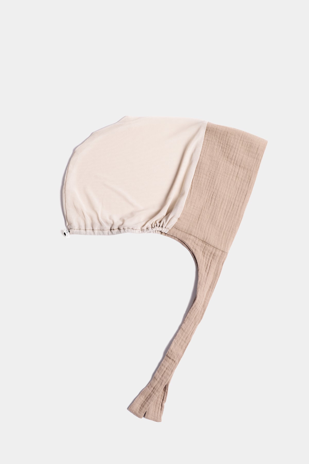 a dark beige two tone  cotton mesh underscarf with ties shown flat against a light gray background.